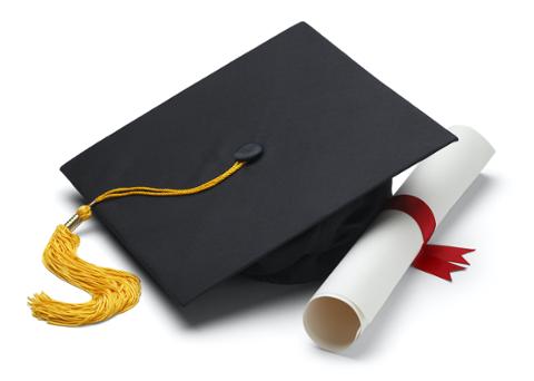 Cyber security degree folded up sitting next graduation cap